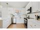 Modern kitchen with white cabinets, stainless steel appliances, and quartz countertops at 6863 W Sunnyside Dr, Peoria, AZ 85345