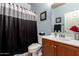Cozy bathroom featuring a shower-tub combo, vanity with sink, and essential fixtures at 7015 W Melody Dr, Laveen, AZ 85339