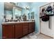 A Primary bathroom featuring double sinks, wood cabinets, tiled floors and bright blue walls at 7015 W Melody Dr, Laveen, AZ 85339