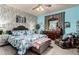 A well-lit bedroom featuring a blue floral-themed bed set and a decorative blue wall at 7015 W Melody Dr, Laveen, AZ 85339