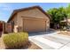 Charming single-Gathering home featuring a two-car garage, desert landscaping, and a covered entryway at 7015 W Melody Dr, Laveen, AZ 85339