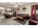 Inviting living room featuring leather furniture, carpet flooring, and open access to other living areas at 7015 W Melody Dr, Laveen, AZ 85339