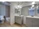 Stylish bathroom with double vanities, modern lighting, and a separate tub and shower area at 722 W Topeka Dr, Phoenix, AZ 85027
