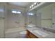 Well-lit bathroom with a tub-shower combo, vanity with sink, and large mirror at 722 W Topeka Dr, Phoenix, AZ 85027