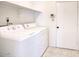 Laundry area featuring a washing machine, dryer, and shelving for storage at 722 W Topeka Dr, Phoenix, AZ 85027