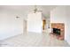 Open-concept living room with tile flooring, brick fireplace, and seamless flow into the kitchen at 722 W Topeka Dr, Phoenix, AZ 85027