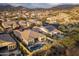 Stunning aerial view showcasing a desert community with pools, tile roofs, and mountain views in the background at 8433 E Leonora St, Mesa, AZ 85207