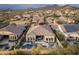Beautiful aerial view of a home with a backyard pool and patio in a scenic community with mountain views at 8433 E Leonora St, Mesa, AZ 85207
