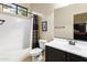 Bright bathroom with a shower/tub combo and dark wood vanity at 8433 E Leonora St, Mesa, AZ 85207