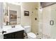 Stylish bathroom featuring a glass shower, pebble floor, and modern fixtures at 8433 E Leonora St, Mesa, AZ 85207
