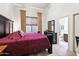 Well-lit bedroom with wood floors, high ceilings, and luxurious furnishings at 8433 E Leonora St, Mesa, AZ 85207