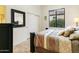 Cozy bedroom featuring wood floors, a closet, and a view of the backyard at 8433 E Leonora St, Mesa, AZ 85207
