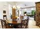 A view of the dining room featuring a wooden table and backyard views through a sliding glass door at 8433 E Leonora St, Mesa, AZ 85207