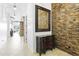 Inviting hallway features a stone accent wall, elegant console table, and decorative mirror at 8433 E Leonora St, Mesa, AZ 85207