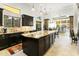 Gourmet kitchen with a granite island, dark cabinetry, stainless steel appliances, and breakfast bar at 8433 E Leonora St, Mesa, AZ 85207