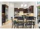 An open concept kitchen with granite countertops, stainless steel appliances, and a breakfast nook with backyard views at 8433 E Leonora St, Mesa, AZ 85207