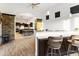 Open kitchen featuring an island bar with seating and dark wood cabinets, leading to dining and living spaces at 8433 E Leonora St, Mesa, AZ 85207