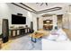 Open-concept living area flows into dining space; features include tray ceilings and stone columns at 8433 E Leonora St, Mesa, AZ 85207