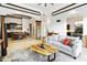 An open floor plan showcases a cozy living room with stone accents and seamless flow to the dining and kitchen areas at 8433 E Leonora St, Mesa, AZ 85207