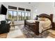 Spacious main bedroom featuring large windows, a decorative bed frame, and tiled floors at 8433 E Leonora St, Mesa, AZ 85207