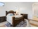 Well-lit main bedroom featuring a decorative bed frame, a decorative rug, and tiled floors at 8433 E Leonora St, Mesa, AZ 85207