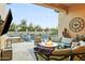 Inviting outdoor patio with a fire pit, lounge seating, and a pool in the background at 8433 E Leonora St, Mesa, AZ 85207