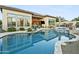 Inviting backyard oasis with sparkling pool, spa, outdoor seating, and covered patio perfect for entertaining at 8433 E Leonora St, Mesa, AZ 85207