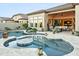 Beautiful backyard pool with cozy outdoor seating and covered patio with views of the home's interior at 8433 E Leonora St, Mesa, AZ 85207