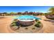 Community pool and sunbathing area featuring a water fountain, comfortable lounge chairs, and a covered picnic spot at 8433 E Leonora St, Mesa, AZ 85207