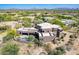 Aerial view captures the estate's sprawling layout, emphasizing the luxury pool and well-manicured desert landscaping at 8606 E Arroyo Seco Rd, Scottsdale, AZ 85266