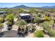 Stunning aerial view of the property, showcasing lush desert landscaping and scenic mountain backdrop at 8606 E Arroyo Seco Rd, Scottsdale, AZ 85266