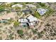 Expansive aerial view of a home with desert landscaping, a private pool, and mountain views at 8606 E Arroyo Seco Rd, Scottsdale, AZ 85266