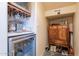 Stylish bar area with wine cooler and wooden cabinet for storage and entertaining at 8606 E Arroyo Seco Rd, Scottsdale, AZ 85266
