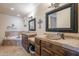 Bathroom with double sinks, soaking tub, tiled floors, and granite countertops at 8606 E Arroyo Seco Rd, Scottsdale, AZ 85266