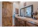 This bathroom boasts decorative vanity with beautiful tiled countertop and dark wood cabinets at 8606 E Arroyo Seco Rd, Scottsdale, AZ 85266