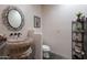 Stylish powder room featuring a vessel sink, decorative mirror, and unique accent pieces at 8606 E Arroyo Seco Rd, Scottsdale, AZ 85266