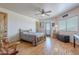 Rustic bedroom features a wooden bed frame, wood floors, and natural light at 8606 E Arroyo Seco Rd, Scottsdale, AZ 85266