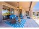 Stylish covered patio with comfortable outdoor seating and a ceiling fan for relaxed outdoor living at 8606 E Arroyo Seco Rd, Scottsdale, AZ 85266