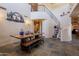 Open dining room with high ceilings and a long rustic dining table at 8606 E Arroyo Seco Rd, Scottsdale, AZ 85266