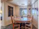 Cozy dining room with a wood table, wooden chairs, and natural light from nearby windows at 8606 E Arroyo Seco Rd, Scottsdale, AZ 85266