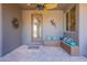 Inviting covered front porch with ceiling fan, tile flooring, and bench seating at 8606 E Arroyo Seco Rd, Scottsdale, AZ 85266