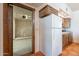 Classic kitchen with a white refrigerator, custom cabinets, and adjacent entrance to a garage at 8606 E Arroyo Seco Rd, Scottsdale, AZ 85266