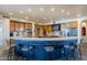 Spacious kitchen with breakfast bar, custom cabinets, stainless steel appliances, and designer backsplash at 8606 E Arroyo Seco Rd, Scottsdale, AZ 85266