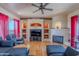 Spacious living room with hardwood floors, fireplace, and built-in shelving at 8606 E Arroyo Seco Rd, Scottsdale, AZ 85266