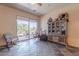 Cozy living room features slate floors, a cabinet display case, and patio access to the pool area at 8606 E Arroyo Seco Rd, Scottsdale, AZ 85266