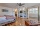 An expansive main bedroom featuring a built-in entertainment center and elegant hardwood floors at 8606 E Arroyo Seco Rd, Scottsdale, AZ 85266