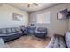 Bright home office featuring tile floors, a ceiling fan, and comfortable seating for work or relaxation at 8606 E Arroyo Seco Rd, Scottsdale, AZ 85266
