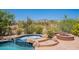 Inviting backyard features a pool, spa and firepit, perfect for outdoor entertaining and enjoying desert views at 8606 E Arroyo Seco Rd, Scottsdale, AZ 85266