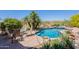 Sparkling swimming pool with a waterfall feature, spa, and desert landscape at 8606 E Arroyo Seco Rd, Scottsdale, AZ 85266