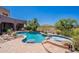 Desert home featuring a sparkling pool, spa, and mountain views framed by mature trees at 8606 E Arroyo Seco Rd, Scottsdale, AZ 85266